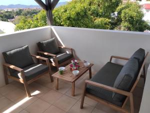 two chairs and a table on a balcony with a view at Kaza LYBS in Fort-de-France