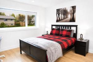 a bedroom with a bed and a window at Centrally Located Modern Suite in North Vancouver