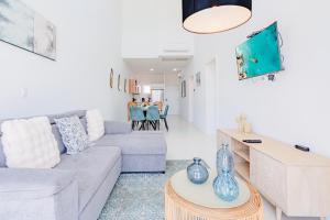 a living room with a couch and a table at Aruba Life 315 in Noord