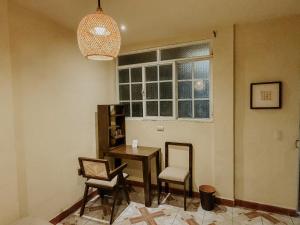 a room with a table and chairs and a window at Zu Suites in San Marcos La Laguna +14 photos