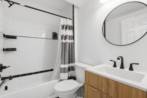 a bathroom with a sink and a toilet and a mirror at Keifer Suite in Detroit +28 photos