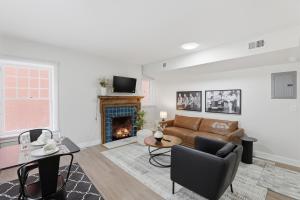 a living room with a couch and a fireplace at Keifer Suite in Detroit