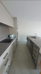a kitchen with white cabinets and a sink and a counter at 111 3rd Avenue Tauranga in Tauranga