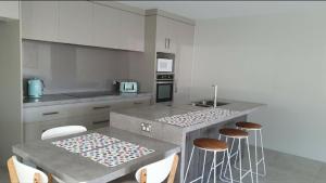a kitchen with a counter and stools in it at 111 3rd Avenue Tauranga in Tauranga