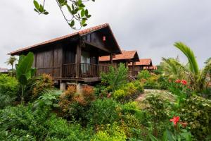 a house in the middle of a garden at The Palm Tree Bungalow in Xuân Sơn
