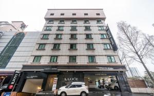 a white car parked in front of a building at Nowon Luxe in Seoul