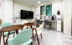 a kitchen and dining room with tables and chairs at Nowon Luxe in Seoul