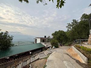 a house on a hill with a green roof at Amber Mount Resorts in Kanthalloor