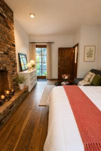a bedroom with a large bed and a fireplace at Evergreen House in Vancouver