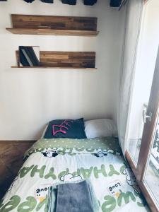 a small bed in a small room with a window at Elegant Studio near Pompidou Center in Paris
