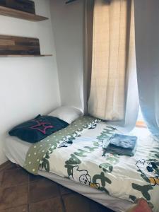 a small bed in a corner of a room at Elegant Studio near Pompidou Center in Paris