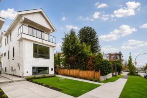 a white house with a yard at Centrally Located Modern Suite in North Vancouver