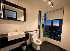 a bathroom with a sink and a toilet and a shower at Minimalist Studio Trefoil Setia Alam linked bridge to Mall and Convention Centre near to NIH Peninsula in Setia Alam +56 photos