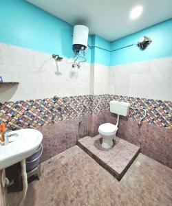 a bathroom with a toilet and a sink at Mona Homestay in Sambalpur