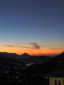 a view of a city at sunset at Chetan's Villa in Bhīm Tāl +14 photos