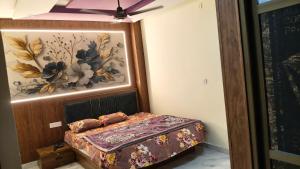 a bedroom with a bed with a painting on the wall at Hotel SR & restaurant in Bhauvāpār