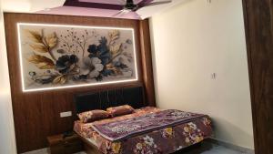 a bedroom with a bed with a painting on the wall at Hotel SR & restaurant in Bhauvāpār +9 photos