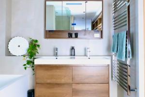a bathroom with a sink and a mirror at Penthouse On The Promenade in Batemans Bay +52 photos
