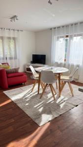 a living room with a table and a red couch at Smart Stay Apartment in Balingen in Balingen