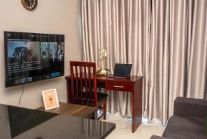 a living room with a desk with a laptop on it at MbaliBliss at Selborne in Bulawayo
