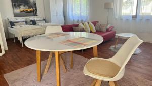 a living room with a table and a couch at Smart Stay Apartment in Balingen in Balingen