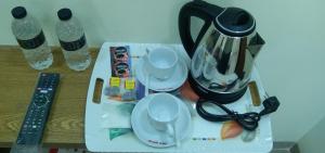 a table with a blender and plates and water bottles at MD HoTEL in Iswardi