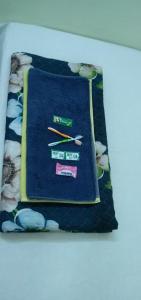 a pillow with a clock and chopsticks on it at MD HoTEL in Iswardi