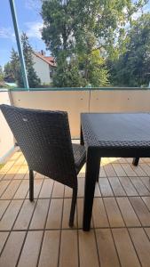 a black table and chair sitting on a patio at Smart Stay Apartment in Balingen in Balingen
