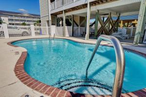 a large swimming pool in the middle of a building at Surf City Stay - Motel Unit - Walk to Beach in Surf City