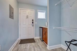 a hallway with a white door and a counter at Surf City Stay - Motel Unit - Walk to Beach in Surf City