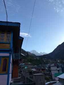 a view of a city with mountains in the background at Sunset Inn tosh in Tosh +170 photos