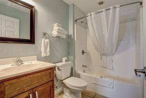 a bathroom with a toilet and a sink and a shower at Surf City Stay - Motel Unit - Walk to Beach in Surf City