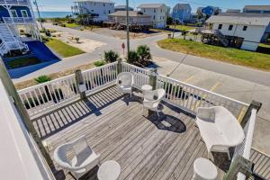 a deck with white chairs and a view of a street at Surf City Stay - Motel Unit - Walk to Beach in Surf City +11 photos