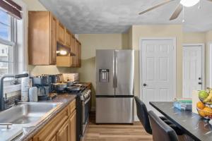 a kitchen with a stainless steel refrigerator and a sink at The Public Street Residence in Providence