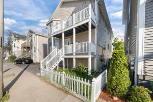 a house with a white fence in front of it at The Public Street Residence in Providence