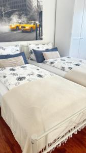 a group of three beds in a room with a window at Smart Stay Apartment in Balingen in Balingen
