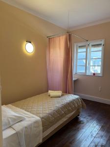 a bedroom with a bed with a curtain and a window at Imperial in Tamengos
