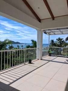 a porch with a view of the ocean at Sunrise Home in Savusavu