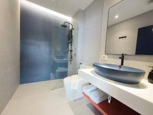 a bathroom with a blue sink and a shower at TERREST MAISON On Nut in Bangkok +46 photos