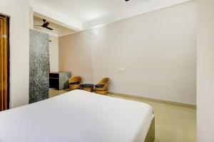 a bedroom with a bed and a pair of shoes at Hotel O Sai villa in Dispur +37 photos