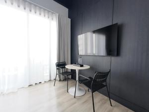 a dining room with a table and chairs at TERREST MAISON On Nut in Bangkok