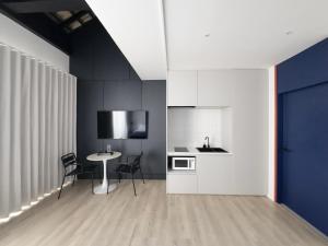 a kitchen with a table and chairs in a room at TERREST MAISON On Nut in Bangkok
