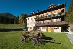 a horse drawn cart in front of a building at Haus Khlemele in Sauris