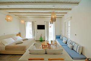 a large room with two beds and a couch at NESEA Boutique Apartments in Hydra