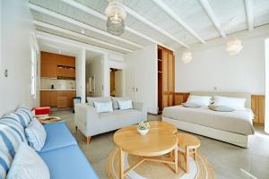 a living room with a couch and a table at NESEA Boutique Apartments in Hydra