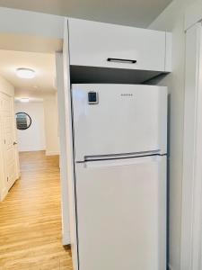 a white refrigerator in a kitchen with a hallway at New & Modern Suite in Bristol Riverview in Riverview