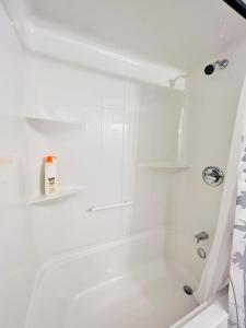 a white bathroom with a tub and a shower at New & Modern Suite in Bristol Riverview in Riverview +51 photos