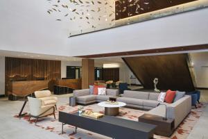 a lobby with couches and chairs and a piano at Sheraton Denver West Hotel in Lakewood
