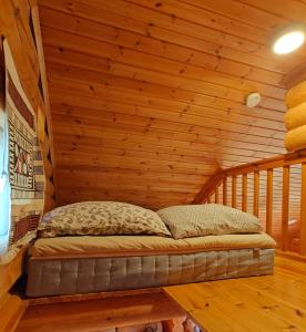 a bed in a room in a log cabin at Kotikolo in Inari