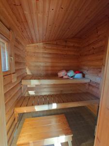 a wooden sauna with a bench in the middle at Kotikolo in Inari